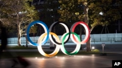 The Olympic rings are seen Monday, March 30, 2020, in Tokyo. The Tokyo Olympics will open next year in the same time slot scheduled for this year's games. 