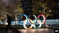 The Olympic rings are seen Monday, March 30, 2020, in Tokyo. The Tokyo Olympics will open next year in the same time slot scheduled for this year's games. 