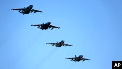 FILE - Russian Su-25 ground attack jets prepare to land after returning from Syria at a Russian air base in Primorsko-Akhtarsk, March 16, 2016.
