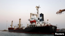 FILE - A ship carrying 5,500 metric tons of flour is docked at the Red Sea port of Hodeidah, Yemen, Nov. 26, 2017.