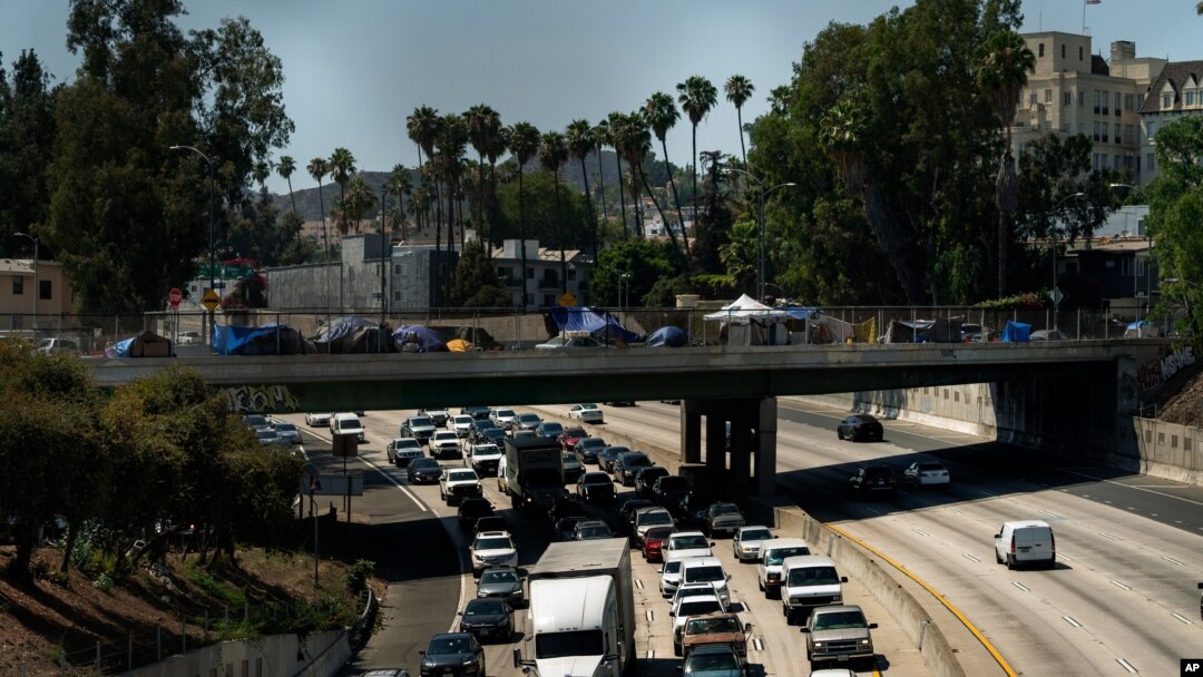 FILE - In this July 7, 2021, file photo homeless encampments are installed on an overpass of the CA-101 Hollywood freeway in Los Angeles. The share of Americans living in poverty rose slightly as the COVID pandemic shook the economy last year, but…