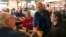 FILE - Sen. Kirsten Gillibrand, D-N.Y. greets patrons at Stomping Grounds Cafe in Ames, Iowa, Jan. 19, 2019.