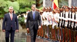 Cuba's President Miguel Diaz-Canel and Spain's King Felipe review an honor guard during a ceremony at the Revolution Palace in Havana, Cuba, Nov. 12, 2019.