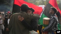 Ecuadorians hug during a Dec. 23, 2024, protest in Quito, Ecuador, after the disappearance in Guayaquil of four children last seen running from a military convoy.