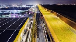 FILE - Aerial view showing trucks queuing near the Mexico-US border while waiting for the port to open in Otay Commercial crossing in Tijuana, Baja California state, Mexico, on March 4, 2025. 