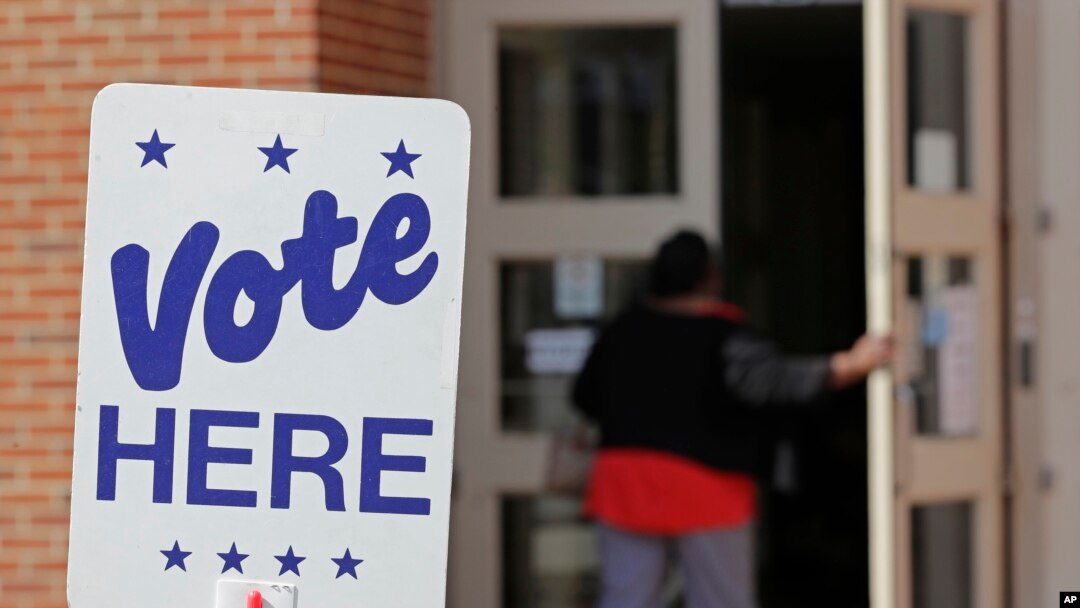 FILE - A polling worker enters a polling place in Charlotte, N.C., April 24, 2019, as early voting began in the Republican primary election for the North Carolina 9th Congressional District, a special election forced by a ballot-collection scandal.