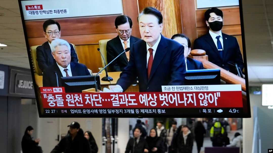 A TV screen shows footage of impeached South Korean President Yoon Suk Yeol's address at the final hearing of his trial during a news program at a bus terminal in Seoul, South Korea, Feb. 25, 2025