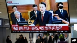 A TV screen shows footage of impeached South Korean President Yoon Suk Yeol's address at the final hearing of his trial during a news program at a bus terminal in Seoul, South Korea, Feb. 25, 2025