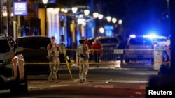 Military personnel stand near the site where people were killed by a man driving a truck in an attack during New Year's celebrations, in New Orleans, Louisiana, Jan. 1, 2025.