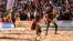 Wrestlers fight during semi-final of the National Sabre, a traditional wrestling competition in Agadez, Niger, on Dec. 31, 2023.
