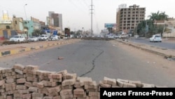 Brick barricades set up by Sudanese anti-coup protesters block a lane of Street 60 in Khartoum East, on Oct. 31, 2021.