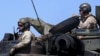 FILE - U.S. Marines sit atop an amphibious assault vehicle during exercises with Philippine marine troops in joint drills at a Philippine Naval base San Antonio, Zambales, Oct. 9, 2015.