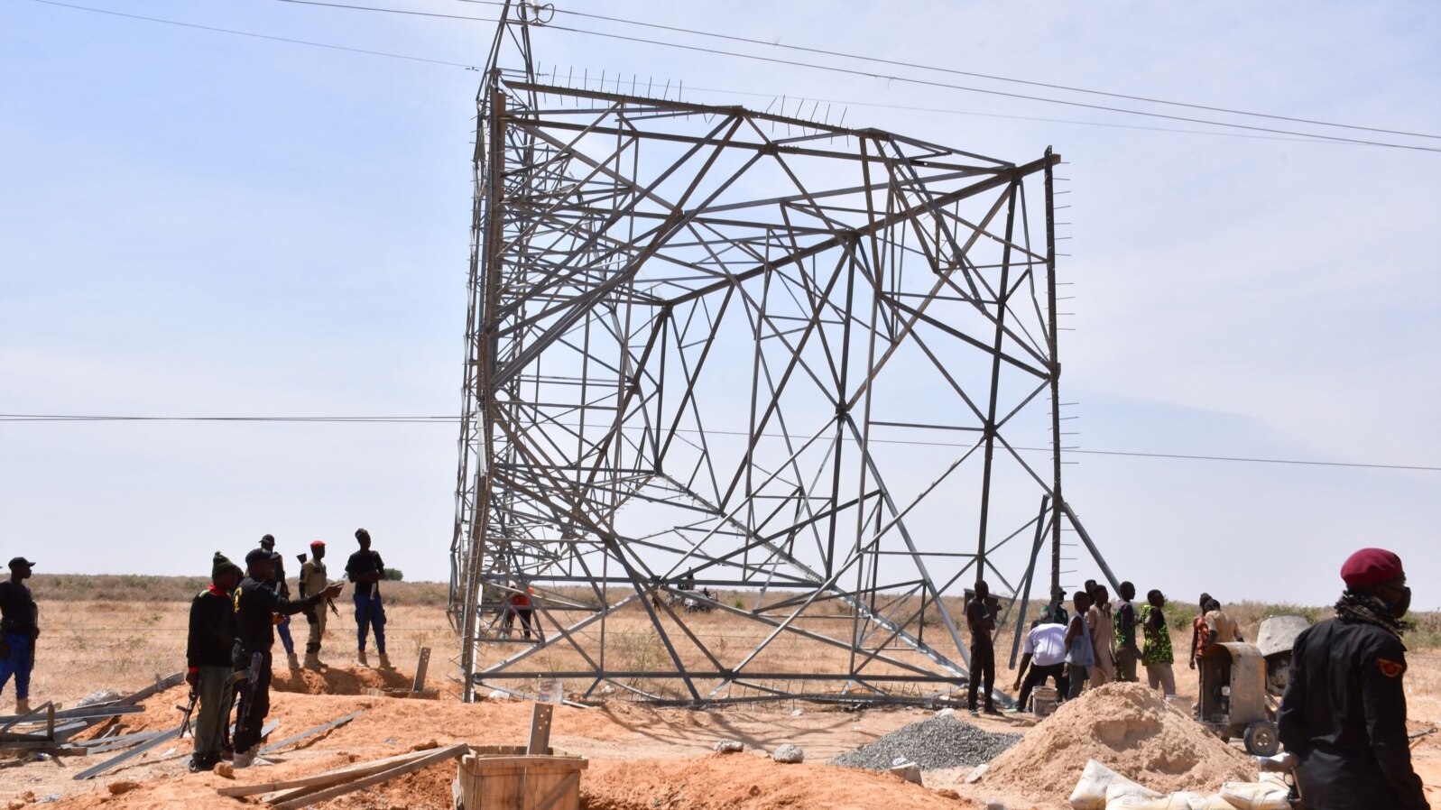 FILE - Nigerian security forces are seen on the site of a sabotage attack against electrical infrastructures on the outskirts of Maiduguri, Feb. 12, 2021. Another attack knocked out power again March 27, 2021. 
