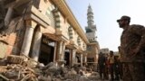 An Army soldier and rescue workers survey the damages, after a suicide blast in a mosque in Peshawar, Pakistan Jan. 31, 2023.