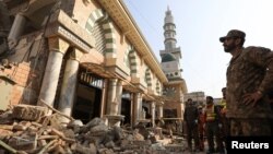 An Army soldier and rescue workers survey the damages, after a suicide blast in a mosque in Peshawar, Pakistan Jan. 31, 2023.