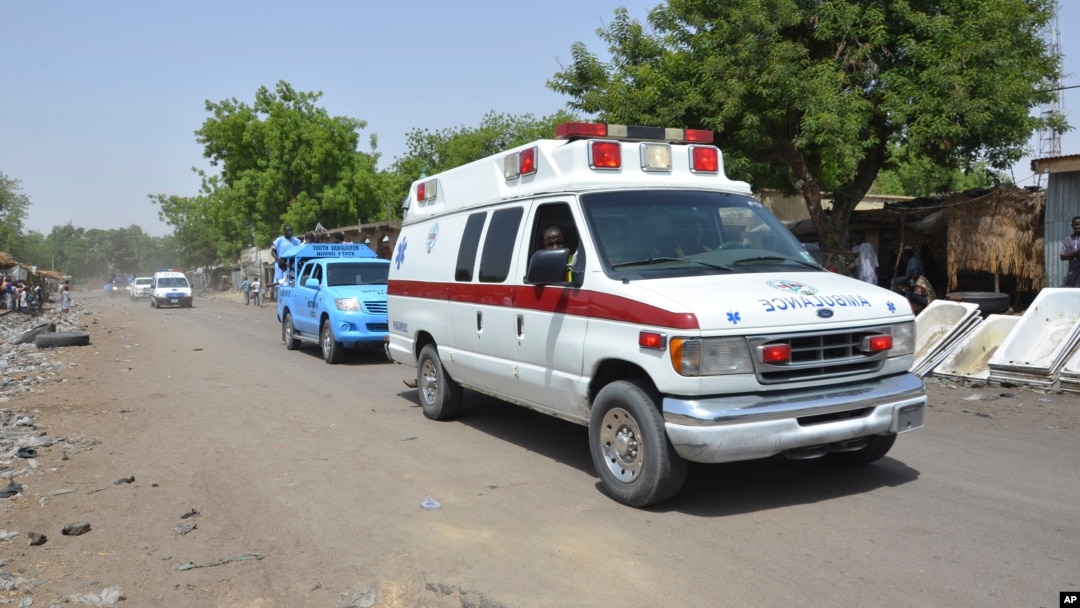 FILE - An ambulance and security vehicles are seen driving to the site of a June 2, 2015, suicide bomb attack in Maiduguri, Nigeria.