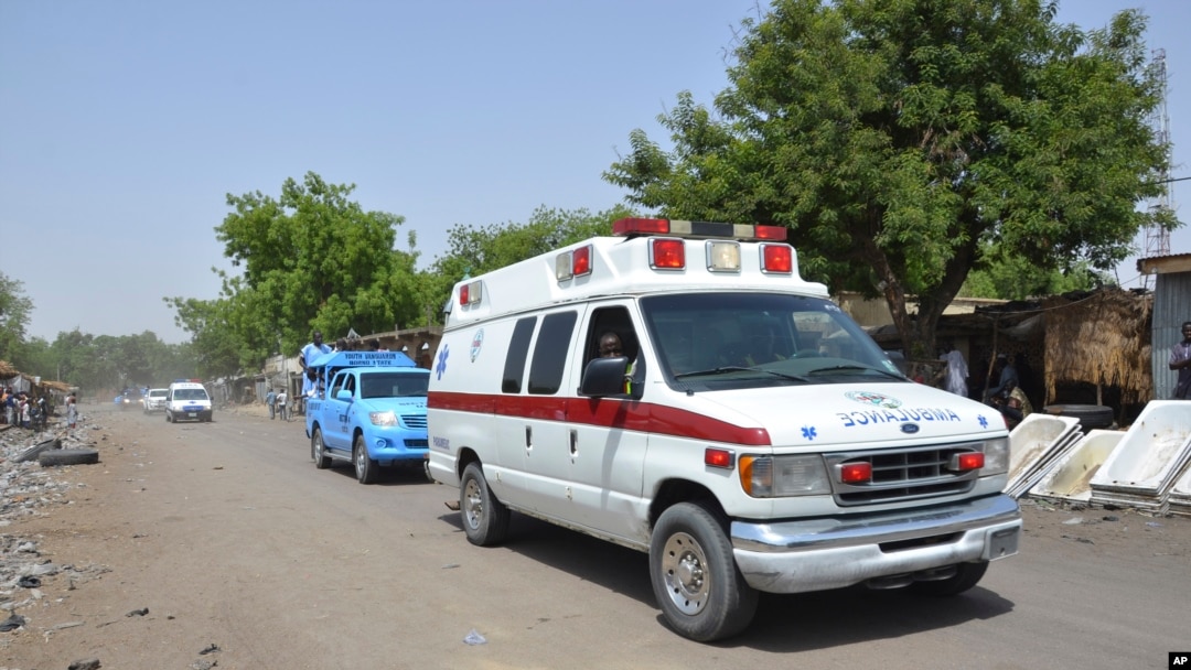 FILE - An ambulance and security vehicles are seen driving to the site of a June 2, 2015, suicide bomb attack in Maiduguri, Nigeria.
