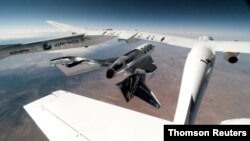 Virgin Galactic's VSS Unity, piloted by CJ Sturckow and Dave Mackay, is released from its mothership, VMS Eve, on the way to its first spaceflight after launch from Spaceport America, N.M., May 22, 2021, in a still image from video. 