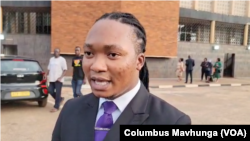 Takunda Jacob from Zimbabwe Lawyers for Human Rights talks to reporters outside the Harare Magistrates Court on November 27, 2024.