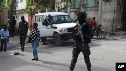 FILE - Police stand guard outside the electoral council headquarters in Port-au-Prince, Haiti, May 31, 2024. Haiti created a provisional electoral council on Sept. 18, 2024, to prepare for its first general elections since 2016. Haiti has not had a president since July 2021.