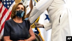 Speaker of the House Nancy Pelosi, D-Calif., receives a Pfizer-BioNTech COVID-19 vaccine shot by Dr. Brian Monahan, attending physician Congress of the United States, in Washington, Dec. 18, 2020.
