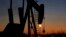 FILE - An oil pump is seen at sunset, in the desert oil fields of Sakhir, Bahrain, Jan. 18, 2016. The political stability of the six Gulf states -- Saudi Arabia, the United Arab Emirates, Qatar, Kuwait, Bahrain and Oman -- is rooted in profits from fossil fuels.