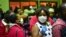 FILE - Travelers wearing face masks as protective measure wait to get their temperature checked at the border post with Kenya in Namanga on March 16, 2020, on the day Tanzania confirmed the first case of COVID-19.