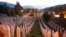 FILE - Gravestones are seen at sunrise at a memorial complex near Srebrenica, 150 kilometers (94 miles) northeast of Sarajevo, Bosnia and Herzegovina, July 11, 2015. 