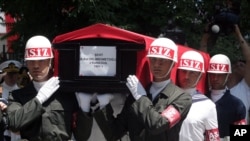 Soldiers carry the flag-covered coffin of one of 13 Turkish soldiers killed southeastern Turkey by Kurdish rebels July 16, 2011.