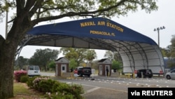 FILE - The main gate at Naval Air Station Pensacola is seen on Navy Boulevard in Pensacola, Fla., March 16, 2016.