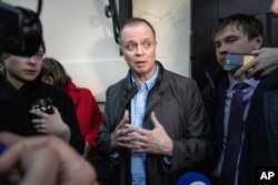 FILE — Russian lawyer Ivan Pavlov, center, is surrounded by journalists after he leaves a court in Moscow, Russia, on April 30, 2021.