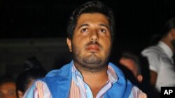 FILE - Turkish-Iranian businessman Reza Zarrab, who is charged in the U.S. for evading sanctions on Iran, watches a concert in Istanbul, Sept. 8, 2013. Turkish prosecutors on Nov. 18, 2017, launched an investigation into two U.S. prosecutors involved in trying Zarrab, according to the country's official news agency.