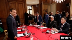 French President Macron (L) attends a meeting with Libyan Prime Minister Fayez al-Sarraj (R) and General Khalifa Haftar (2ndR), commander in the Libyan National Army (LNA) in La Celle-Saint-Cloud, France, July 25, 2017. 