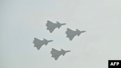 Chinese-made Chengdu J-20 stealth fighters fly in formation during the 15th China International Aviation and Aerospace Exhibition in Zhuhai, in south China's Guangdong province on November 12, 2024.