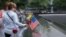 Visitors touch the names of the victims of the Sept. 11, 2001, terror attacks at New York's National September 11 Memorial, Sept. 11, 2015. Survivors and relatives of the nearly 3,000 people killed in the attacks might be able to soon sue Saudi Arabia for damages.