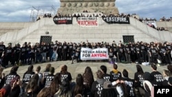 FILE —This complete handout provided by the Jewish Voice for Peace includes activists calling for a ceasefire between Israel and Hamas in the Gaza Strip at the Statue of Liberty in New York on November 6, 2023. On November 13, the group and its allies protested in Chicago.