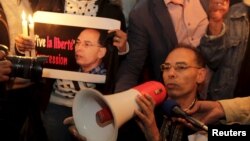 FILE - Maati Monjib, a professor of political history and African studies at the University of Rabat and a writer for national and international news organisations, and his supporters participate in a demonstration near the Moroccan Human Rights Associati