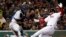 Boston Red Sox's Sandy Leon scores as New York Yankees catcher Gary Sanchez doesn't handle the throw during the second inning of a baseball game at Fenway Park in Boston on April 12, 2018. 