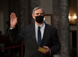 Vice President Mike Pence administers the oath of office to Sen. Jeff Merkley, D-Ore., during a reenactment ceremony in the Old Senate Chamber at the Capitol in Washington, Jan. 3, 2021.