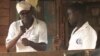 FILE: Joseph Shiroko, founder of Brian Resource Center, communicates with a student in sign language