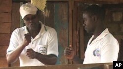 Joseph Shiroko, founder of Brian Resource Center, communicates with a student in sign language