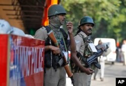 FILE - Indian security personnel guard outside the civil secretariat of the Union territory of Jammu and Kashmir during the annual reopening of the former state's winter capital in Jammu, India, Nov. 4, 2019.
