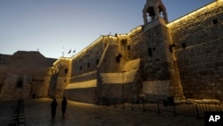 Nuns walk along the Church of the Nativity, traditionally believed to be the birthplace of Jesus, on Christmas Eve, in the West Bank city of Bethlehem, Dec. 24, 2024. 