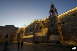 Nuns walk along the Church of the Nativity, traditionally believed to be the birthplace of Jesus, on Christmas Eve, in the West Bank city of Bethlehem, Dec. 24, 2024.