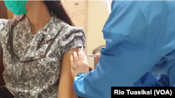 Seorang sukarelawan menerima suntikan vaksin dalam simulasi tes vaksin Covid-19 di Fakultas Kedokteran Universitas Padjajaran, Bandung, 5 Agustus 2020. (Photo: VOA / Rio Tuasikal)