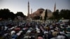 Muslims offer evening prayers outside the Byzantine-era Hagia Sophia, one of Istanbul's main tourist attractions in the historic Sultanahmet district of Istanbul, July 10, 2020. 