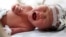 An abandoned newborn baby cries in an incubator after he was rescued from a sewage pipe at a hospital in Jinhua, Zhejiang province May 28, 2013.