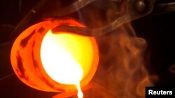 Liquid gold is poured into a mould at the Austrian Gold and Silver Separating Plant 'Oegussa' in Vienna.