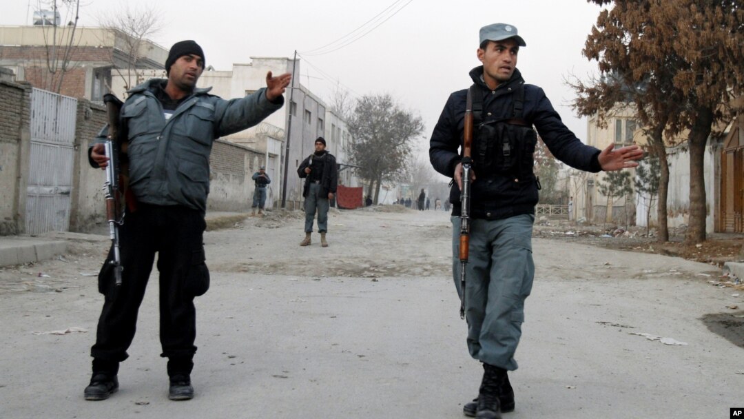 Afghan policemen stand guard near the scene where Afghanistan's Intelligence Chief Asadullah Khalid was wounded in an assassination attempt in Kabul, Afghanistan, December 6, 2012.