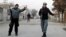 Afghan policemen stand guard near the scene where Afghanistan's Intelligence Chief Asadullah Khalid was wounded in an assassination attempt in Kabul, Afghanistan, December 6, 2012.